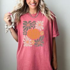 This boho style pumpkin t-shirt is the perfect addition to your fall wardrobe. With its cozy vibes and playful Halloween design, it's sure to be a hit at any autumn event. Express your love for the season in a stylish and unique way. Halloween Design, Fall Wardrobe, Blue Jeans, Boho Fashion, Wardrobe, T Shirt