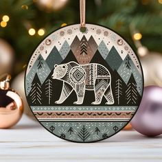 a christmas ornament with an image of a bear in the woods on it