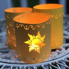 two lit candles sitting on top of a table