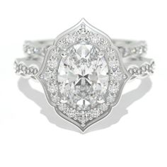 a white gold ring with an oval cut diamond in the center and pave set shoulders