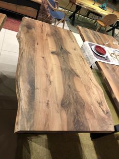 a wooden table sitting on top of a tiled floor