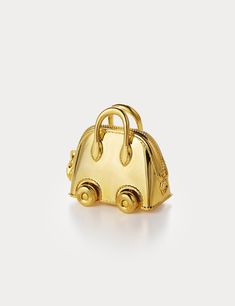 Inspired by Hermes Bolide On Wheels Bag Charm, Aelysee has meticulously crafted the Mini Bolide On Wheels Bag Charm, incorporating unique design elements. The charm features a separate clasp and chain, allowing you to customize it effortlessly with any of your handbags. Electroplated brass Charm size - 30 x 18.3 x 28.8mm Total weight 38g One year warranty Small Elegant Shoulder Bag With Dust Bag, Small Elegant Shoulder Bag, Yellow Gold Top Handle Bag For Everyday Use, Luxury Shoulder Bag With Detachable Handle As Gift, Small Luxury Evening Bag, Small Luxury Evening Bags, Yellow Gold Rectangular Travel Bag, Luxury Gold Bag Charm As Gift, Luxury Small Travel Bags