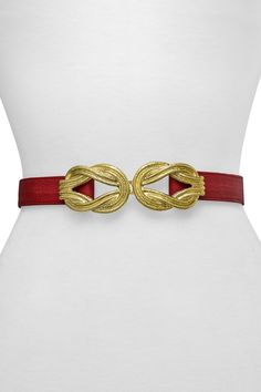 A gold-tone buckle in an eternity knot shape adds an intricate detail to a classic leather belt. Eternity knot buckle with hook closure. Leather construction. Approx. 1.25" width. Imported Elegant Formal Belt With Gold-tone Hardware, Classic Gold Belt Buckle, Chic Formal Belt Buckle With Gold-tone Hardware, Luxury Belt With Brass Buckle For Formal Wear, Chic Formal Belt Buckles With Gold-tone Hardware, Luxury Belt With Brass Buckle For Formal Occasions, Elegant Leather Belt With Gold Buckle, Designer Formal Belt With Brass Buckle, Elegant Gold Leather Belt Buckles