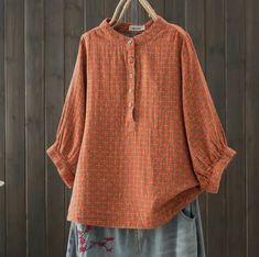 This blouse is crafted from double-layer cotton gauze, offering a lightweight and breathable feel. This blouse also has 3/4 sleeves adding a touch of elegance and comfort. Orange Long Sleeve Blouse With Relaxed Fit, Orange Relaxed Fit Long Sleeve Blouse, Spring Cotton Blouse With Half Sleeves, Spring Half-sleeve Cotton Blouse, Spring Orange Linen Top, Fall Cotton Short Sleeve Peasant Top, Fall Cotton Peasant Top With Short Sleeves, Fall Short Sleeve Cotton Peasant Top, Orange Fall Blouse For Daywear