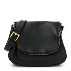 This is an authenticTOM FORD Grained Calfskin Medium Jennifer Crossbody Bag in Black. This shoulder bag is crafted of grained calfskin leather in black. The bag features a front exterior pocket, a leather shoulder strap with decorative polished gold zippers and a decorative zipper along the base. The fold over top opens to a black suede interior with a zipper pocket. Luxury Black Saddle Bag In Soft Leather, Tom Ford Jennifer Bag, Tom Ford Bag, Crossbody Bag Black, The Fold, Gold Zipper, Black Cross Body Bag, Fold Over, Tom Ford