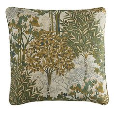 a decorative pillow with an image of trees on the front and back, along with other foliage