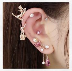 an ear with several different types of piercings on it