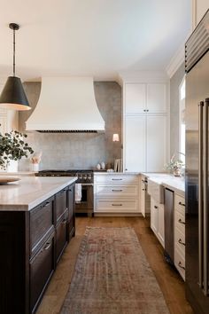 a kitchen with an area rug on the floor