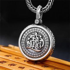 As a gift for your loved ones, this limited-stock Sterling Silver Rotatable Attracting Wealth Pendant Necklace will be perfect!SPECIFICATIONSMetal Type: 925 Sterling SilverStyle: VintageChain Length: 550 mm (21.7 in)Pendant Size: 23*8.5 mm (0.90*0.33 in)Pendant Weight: 20 gMADE WITH 925 STERLING SILVERAll of our pieces are handmade, and most of them are constructed from 925 sterling silver. It is the quality of our craftsmanship and the unique designs that help us to stand out from the crowd. We are proud to be different.With PayPal, you can send payment quickly and securely online.Through PayPal, you can pay with a credit card, debit card, or bank account balance.Once your order is submitted, you will be redirected to PayPal’s site where you could make the payment.Attention: All orders ar Engraved Spiritual Jewelry, Spiritual Engraved Jewelry As Gift, Engraved Spiritual Jewelry For Gifts, Traditional Silver Box Chain Jewelry, Spiritual Sterling Silver Necklace Gift, Spiritual Sterling Silver Necklace, Spiritual Sterling Silver Necklace Ideal For Gifting, Personalized Silver Necklace For Meditation, Sterling Silver Jewelry For Blessing