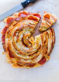 the pizza has been sliced into slices and is ready to be eaten with a knife