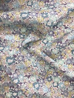 the fabric is very colorful and has many flowers on it