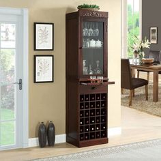 a tall wooden cabinet with wine glasses on it's door and shelves in the corner