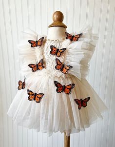 This Boho Butterfly Dress is made with a beige lace fabric. It is adorned with tulle and embellished with Monarch Butterflies. The back of the romper has an open back, giving it the perfect look. It will be enclosed with a tulle ribbon.  All of my items are made in a smoke free home and will be mailed in a box to ensure safety of the romper.   Size Chart                                                Measured in Inches                             Newborn/Preemie:     Chest - 15.5 Waist - 16 Hips Cream Tulle Dresses With Lace Bodice, Cream Tulle Dress With Lace Bodice, Cream Ruffled Tutu Dress For Party, Garden Party Tulle Dress With Lace Patchwork, Cream Tulle Dress For Garden Party, Cream Tulle Dresses With Ruffles, Cream Tulle Dress With Ruffles, Fitted Cream Tutu Dress With Ruffles, Cream Tulle Dress For Dress-up