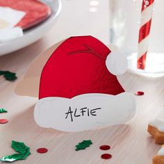 a red santa hat sitting on top of a table