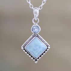 Two frosty gems, one stacked atop the other, sparkle on Neeru Goel's delicate pendant necklace. Indian artisans use a faceted blue topaz gem and a cloudy larimar stone to create the pendant, which swings from a sleek sterling silver cable chain. Larimar Gemstone Pendant Necklaces, Larimar Gemstone Pendant Necklace, Sterling Silver Faceted Square Pendant Jewelry, Faceted Sterling Silver Square Pendant Jewelry, Elegant Larimar Pendant Jewelry, Aquamarine Pendant Jewelry With Natural Stones, Aquamarine Pendant With Natural Stones, Larimar Gemstone Jewelry For Anniversary, Spiritual Larimar Pendant Jewelry