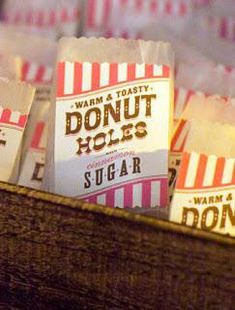 several bags of donut holes sitting in a wooden basket on top of a table