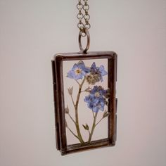 "Real flower Necklace in your chose of Blue Forget Me Not flowers or red Scarlet Gilia flowers that are dried, pressed and preserved between glass in a beautiful antique copper rectangular pendant that is 1.62\" x 1\" and includes an antique brass chain in either a 18\", 20\" or 24\" length for you to choose upon checkout. To preserve the color of the flowers and leaves, please keep out of direct sun. Remove when bathing or swimming. Clean glass with a soft cloth, do not use chemicals. This was Pressed Flowers Flower Pendant Necklace For Birthday, Pressed Flowers Keepsake Jewelry, Flower Pendant Necklace With Pressed Flowers For Birthday, Birthday Gift Flower Pendant Necklace With Pressed Flowers, Pressed Flowers Pendant Necklace For Mom, Nature-inspired Flower Necklace With Pressed Flowers For Gifts, Vintage Flower Necklaces With Pressed Flowers, Vintage Flower Necklace With Pressed Flowers, Pressed Flowers Necklace For Mother's Day Keepsake