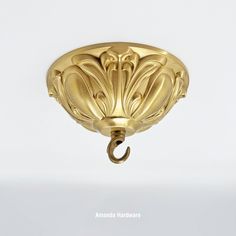 an ornate brass light fixture on a white background