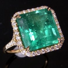 LAYAWAY PLANS AVAILABLE PLEASE CONTACT US FOR DETAILS  Style: You are looking at a custom made stunning  Emerald and Diamonds cocktail ring.  The ring features a beautiful  5.6ct step  cut Green Colombian Emerald surrounded by  .81ct  of VS clarity Diamonds.   The setting is 18K solid yellow gold.  Size of the ring is impressive with front measuring  approximately 1.4cm x 1.4cm.  This ring can make an amazing engagement ring fit for royalty or just be a stunning cocktail piece.  Please note, thi Columbian Emeralds, Best Engagement Rings, White Gold Wedding Rings, Colombian Emeralds, Emerald Engagement, Emerald Jewelry, Emerald Ring, Cocktail Ring, Cocktail Rings