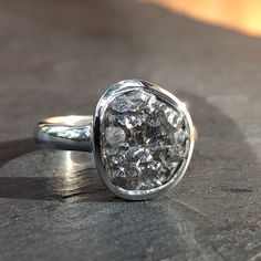 a diamond ring sitting on top of a wooden table