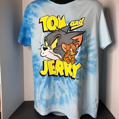 New With Tags Tom And Jerry Tie Dye Tee Shirt Color: Blue/Gray Size: Men’s Large Blue Pre-shrunk Shirt For Fan Merchandise, Blue Fan Merchandise T-shirt For Summer, Blue Shirt With Screen Print For Fan Merchandise, Blue Summer Fan Merchandise T-shirt, Blue Shirt With Letter Print For Fan Merchandise, Casual Blue Shirt With Letter Print, Blue Short Sleeve Shirt For Fan Merchandise, Casual Light Blue Pre-shrunk Shirt, Blue Gray Color