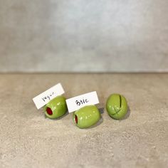 three pieces of fruit with words written on them sitting on a counter next to each other