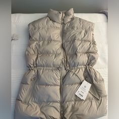 New With Tags Sporty Nylon Vest For Winter, Sporty Spring Vest For Outdoor Activities, Sporty Winter Vest For Outdoor Activities, Sporty Winter Outdoor Vest, Sporty Outdoor Winter Vest, Winter Functional Solid Vest, Functional Solid Winter Vest, Functional Solid Color Winter Vest, Sporty Spring Puffer Outerwear