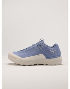 a blue sneaker with white soles is shown