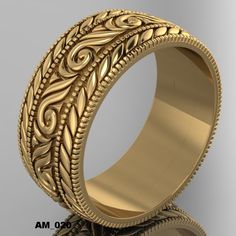 a gold wedding ring with intricate designs on the outside and inside, sitting on a reflective surface