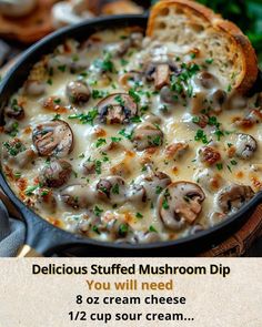 a pan filled with cheese and mushrooms on top of a wooden table next to bread