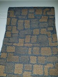 a brown and blue tie with squares on it