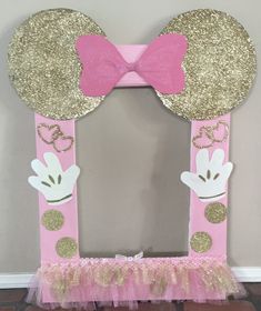 a pink and gold minnie mouse mirror frame