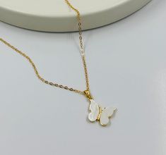 "Dainty necklace and Elegant to add to any outfit. It is the perfect gift for many celebrations such as birthdays, Gifts for the Wife, and Mother's Day. This Delicate 18 K Gold Butterfly Cubic Zirconia Charm is available in 16\" 14K Dainty Necklace Chain Gold for Layering. Chain Style:  Ball Chain 1,5 mm w/2\" Extender Chain. Diamond Chain 1 mm w/2\" Extender Chain. Oval Chain 1 mm w/2\" Extender Chain. You can also write to me if you need any information about the Necklace or have any questions White Delicate Chain Charm Necklace As A Gift, White Charm Necklace With Delicate Chain For Gift, Handmade White Charm Necklaces For Birthday Gift, White Charm Necklaces For Mother's Day Gift, White Charm Necklace For Mother's Day Gift, White Charm Necklace With Adjustable Chain As Gift, White Pendant Charm Necklace For Birthday, White Necklace With Delicate Chain For Her, White Charm Necklace With Adjustable Chain For Mother's Day