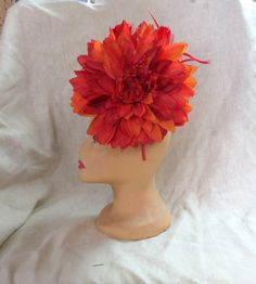 One of a kind, beautiful Fascinator Hat headband. This features a firey red orange dahlia flower. It is very large and stunning. The photos don't really do it justice very beautiful in person. Perfect for weddings or to wear to the Kentucky Derby. Our sweater crew love to display their talents on other things other than sweaters, this is just one example. You can show this off at any event, or just out for coffee. Red Summer Fascinator With Handmade Flowers, Red Handmade Flowers Fascinator For Summer, Summer Red Fascinator With Handmade Flowers, Red Adjustable Fascinator For Garden Party, Adjustable Red Fascinator For Garden Party, Adjustable Red Fascinator With Handmade Flowers, Red Headpieces With Handmade Flowers, Adjustable, Adjustable Red Headpiece With Handmade Flowers, Red Adjustable Headpiece With Handmade Flowers