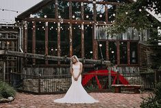 a bride standing in front of a barn