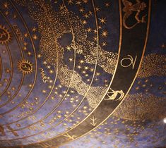 the ceiling is decorated with gold stars and zodiacs on it's sides, as well as other astrological symbols