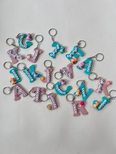 a bunch of key chains that are shaped like letters