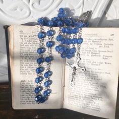 Beautiful blue colored vintage rosary . Acrylic medium Faceted beads and a silver detailed crucifix ,and a Lourdes Holy Water medallion centerpiece and links. Rosary is in perfect condition! Beautiful for a decor piece. The colors are beautiful! Nice for making a Altered Necklace... 22 inch drop...so total length is 44 inches Rosary With Faceted Beads And Crucifix, Blue Rosary With 8mm Beads And Crucifix, Handmade Blue Rosary With Cross Shape, Handmade Blue Rosary With Cross, Blue Rosary With 8mm Beads In Cross Shape, Cross Chain, Holy Water, Spiritual Healing, Faceted Bead