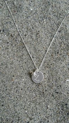 Beautiful. Simple. 12mm sterling silver disk is monogrammed with your initial in either Monogram script or Ariel font. Please see last photo for an example of both fonts. It has a tiny sterling silver puffed star charm hanging beside it. Perfect everyday necklace or for a bridesmaid group! Please message me if you would like more than the quantity listed. I can produce custom orders of any quantity. Also available in gold with silver star as seen in last photo and available here: https://www.ets Personalized Sterling Silver White Gold Initial Necklace, Personalized Sterling Silver Initial Necklace In White Gold, Silver Minimalist Personalized Initial Necklace, Dainty Silver Monogram Charm Necklace, Dainty Sterling Silver Monogram Charm Necklaces, Dainty Personalized Silver Charm Necklaces, Silver Dainty Monogram Charm Necklace, Sterling Silver Engraved Initial Pendant Charm Necklaces, Silver Monogram Dainty Charm Necklace