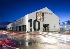 a building with the number ten on it's side and lights streaking by