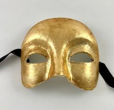 This Venetian half mask is perfect for any masquerade event.  Simple yet elegant.  The mask is handmade from paper mache and then decorated in gold leaf. The mask's dimensions are approximately 6" wide, 5" high and 3 ½" deep. All masks are handmade in Venice, Italy.  No two masks are ever identical. Masquerade Event, Venetian Masquerade Masks, Venetian Masquerade, Masquerade Masks, Half Mask, Costume Masks, Half Face Mask, Feuille D'or, Half Face