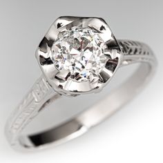 an antique style diamond engagement ring with filigrees