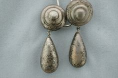 This is the perfect option for those who like cool, unique jewelry and the luxury, shine of sterling. This earrings are well made, cute and/or elegant in design, and very desirable. The earrings have the shape of disk with drops. The earrings have color of silver. They have patina. The clasps are in very good working condition. ♥ Age/era: Circa 1960s - 1980s. ♥ There are a hallmark. 925 ♥ The earrings are about 1 7/8'' by 5/16'' Every one interested in the jewelry should remember that he or she Vintage Silver Teardrop Clip-on Earrings, Silver Teardrop Metal Clip-on Earrings, Nickel Free Silver Teardrop Clip-on Earrings, Nickel-free Silver Teardrop Clip-on Earrings, Unique Silver Metal Clip-on Earrings, Silver Teardrop Nickel-free Clip-on Earrings, Unique Silver Dangle Clip-on Earrings, Silver Teardrop Clip-on Earrings For Formal Occasions, Modern Silver Teardrop Clip-on Earrings