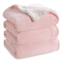 three pink blankets stacked on top of each other