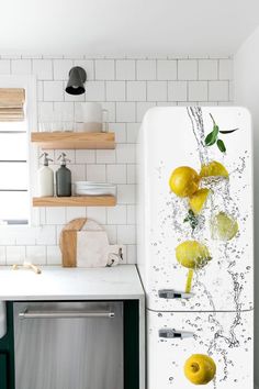 a white refrigerator freezer sitting inside of a kitchen