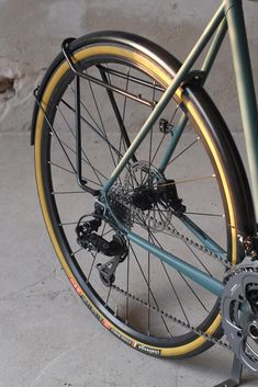 a close up of a bike on a concrete floor with the spokes still attached