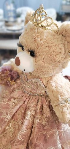 a teddy bear wearing a dress and a tiara