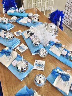 the table is set with blue and silver decorations