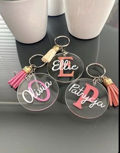 three personalized acrylic key chains with tassels