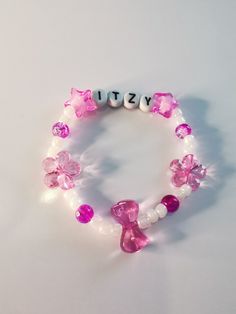 Handmade beaded bracelet. #strayKids #skz #skzstay #kpop #kpopbracelet #beadedbracelet #beadsbracelet #beads #jewelry #atiny #etsy #itzy #blackpink #nct #Seventeen #twice #txt #enhypen #exo #mamamoo #newjeans #nmixx #ive #ateez Casual Pink Name Bracelet For Birthday, Trendy Birthday Charm Bracelet, Trendy Pink Hypoallergenic Bracelets, Trendy Pink Hypoallergenic Stretch Bracelet, Cute Pink Wristband With Letter Beads, Trendy Pink Charm Bracelet With Letter Beads, Casual Customized Pink Name Bracelet, Casual Handmade Pink Name Bracelet, Trendy Pink Stretch Bracelet For Party